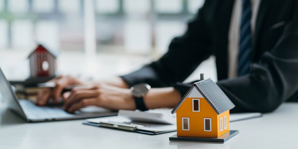 Real Estate concept, Agent to present the property .price for loan investment chart graph documents and calculating table payment to customer.